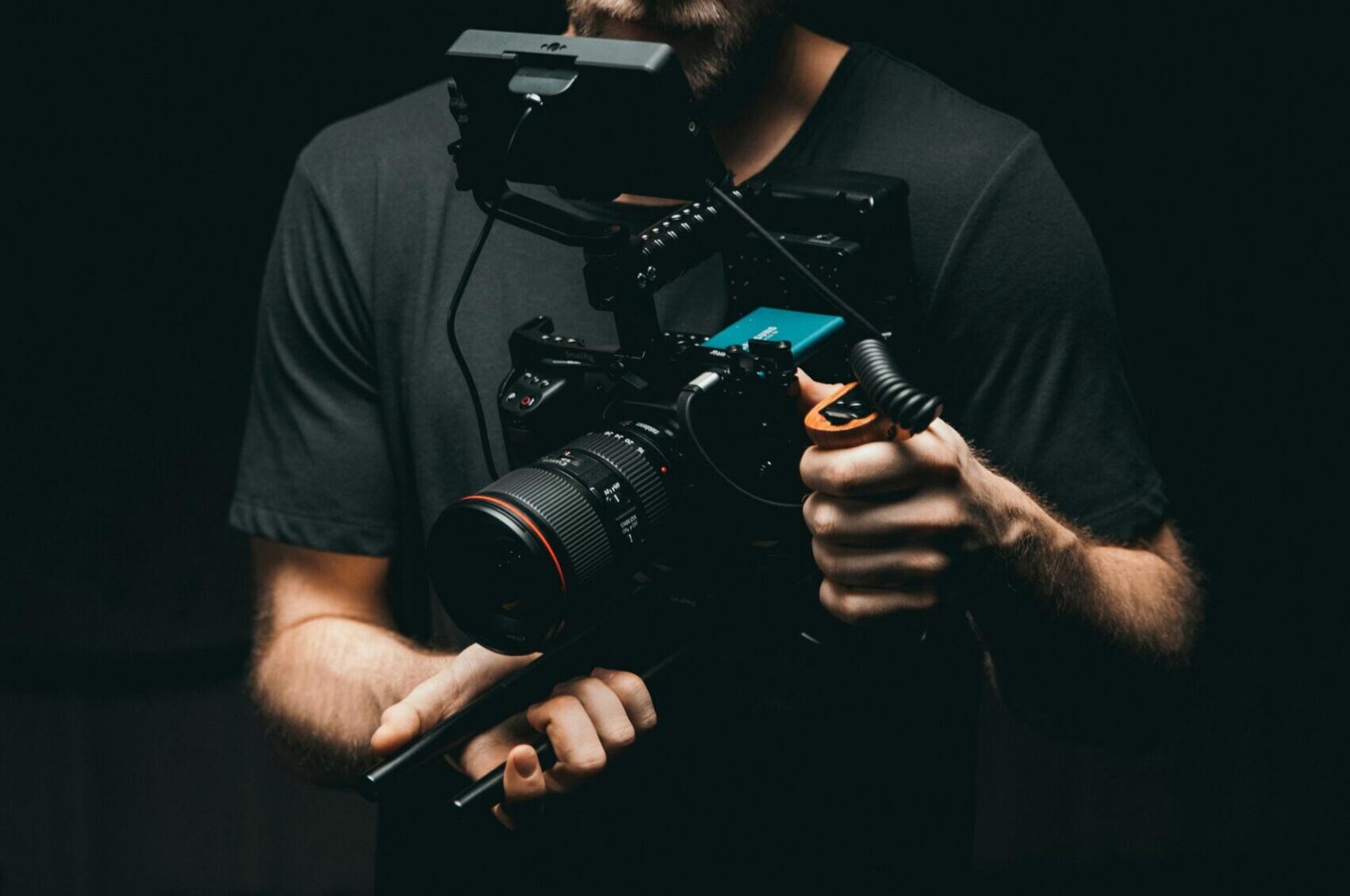 A cinematographer adjusts a camera rig with precision, ready for the next scene.